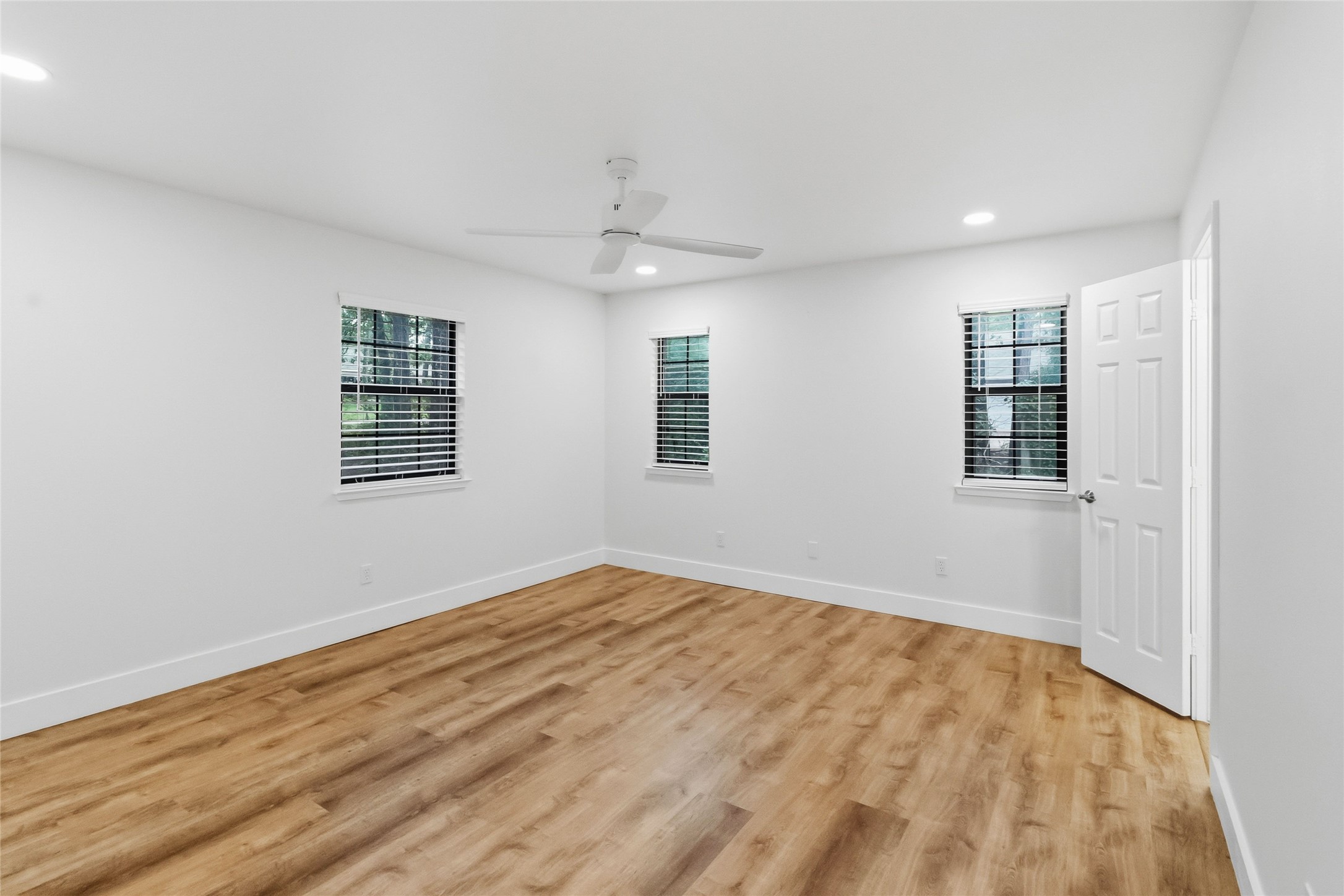 326 Pine View Loop Bastrop, TX 78602 - Photo 18 of 30 A naturally illuminated room features light hardwood flooring and modern ceiling fan.