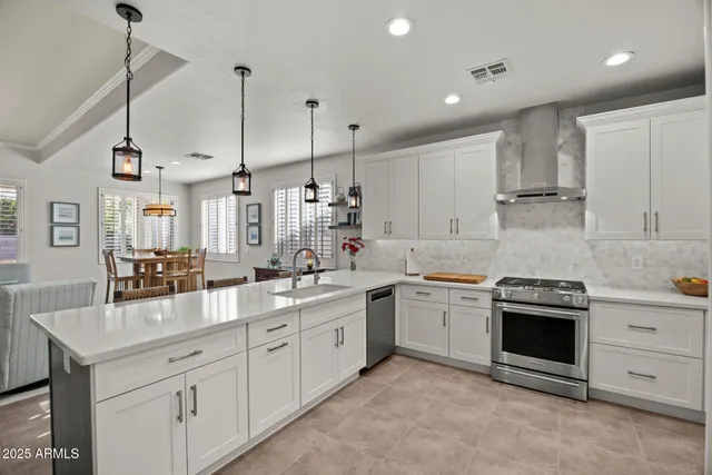 a kitchen with white cabinets stainless steel appliances and sink
