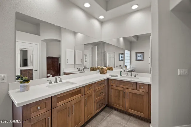 a bathroom with a sink vanity granite and a mirror