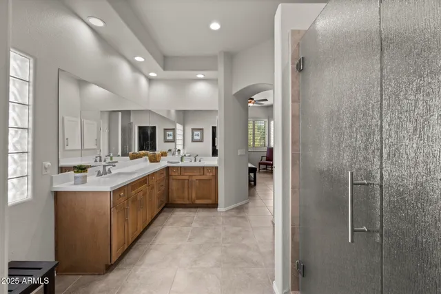 a large white kitchen with a large window