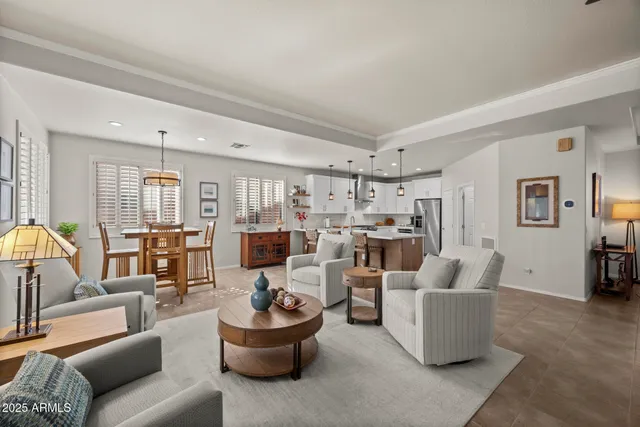 a living room with furniture and a view of kitchen