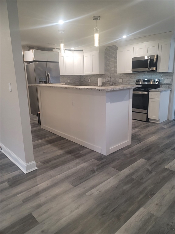 19 Saugus Avenue, Unit 2 Saugus, MA 01906 - Photo 5 of 13 a kitchen with stainless steel appliances granite countertop a sink a stove a refrigerator and cabinets