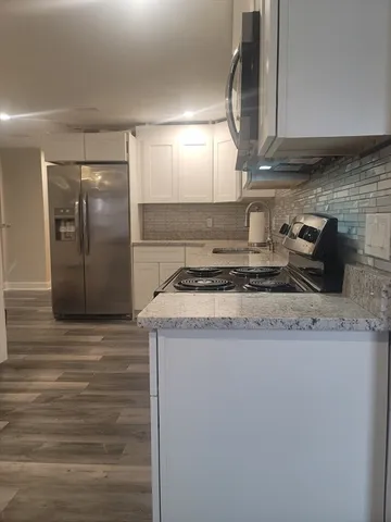 a kitchen with granite countertop a sink and a stove