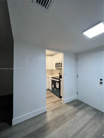 a kitchen with a stove and a microwave