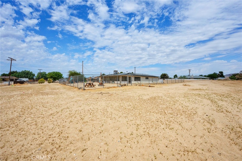 18251 Hiawatha Road Apple Valley, CA 92307 - Photo 13 of 58 a view of swimming pool and brick building in the background