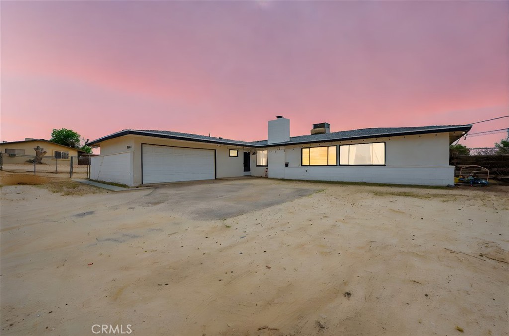 18251 Hiawatha Road Apple Valley, CA 92307 - Photo 2 of 58 a front view of a house with a yard and garage