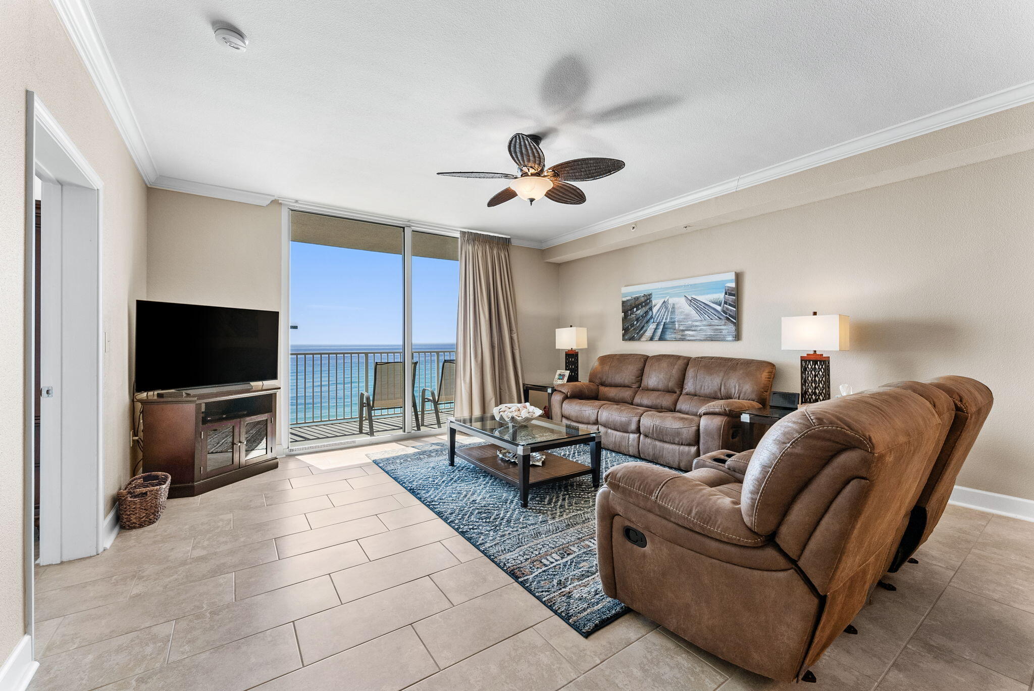 16819 Front Beach Road, Unit 405 Panama City Beach, FL 32413 - Photo 12 of 48 a living room with furniture a flat screen tv and a chandelier