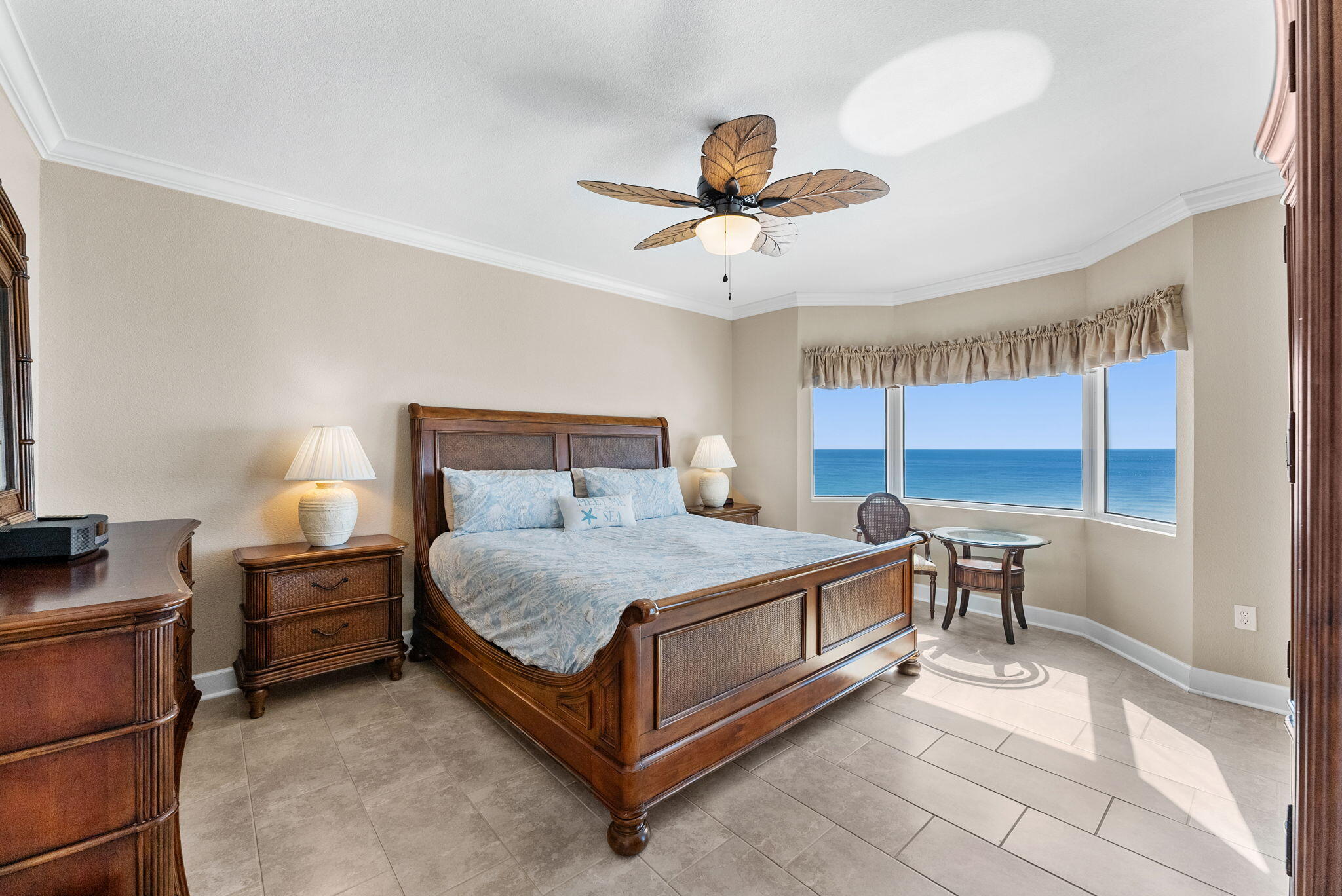 16819 Front Beach Road, Unit 405 Panama City Beach, FL 32413 - Photo 15 of 48 a bedroom with a bed and a chandelier