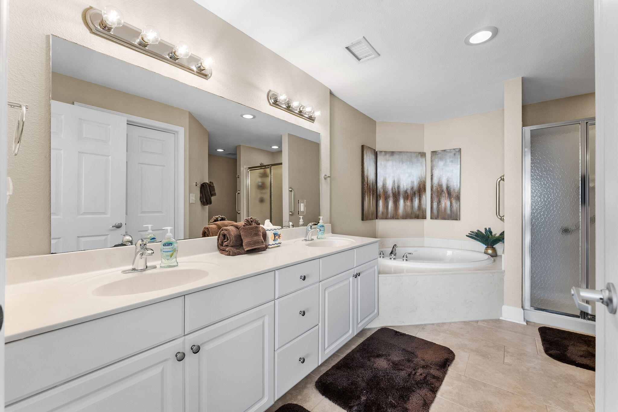 16819 Front Beach Road, Unit 405 Panama City Beach, FL 32413 - Photo 19 of 48 a spacious bathroom with a double vanity sink a mirror and a bathtub