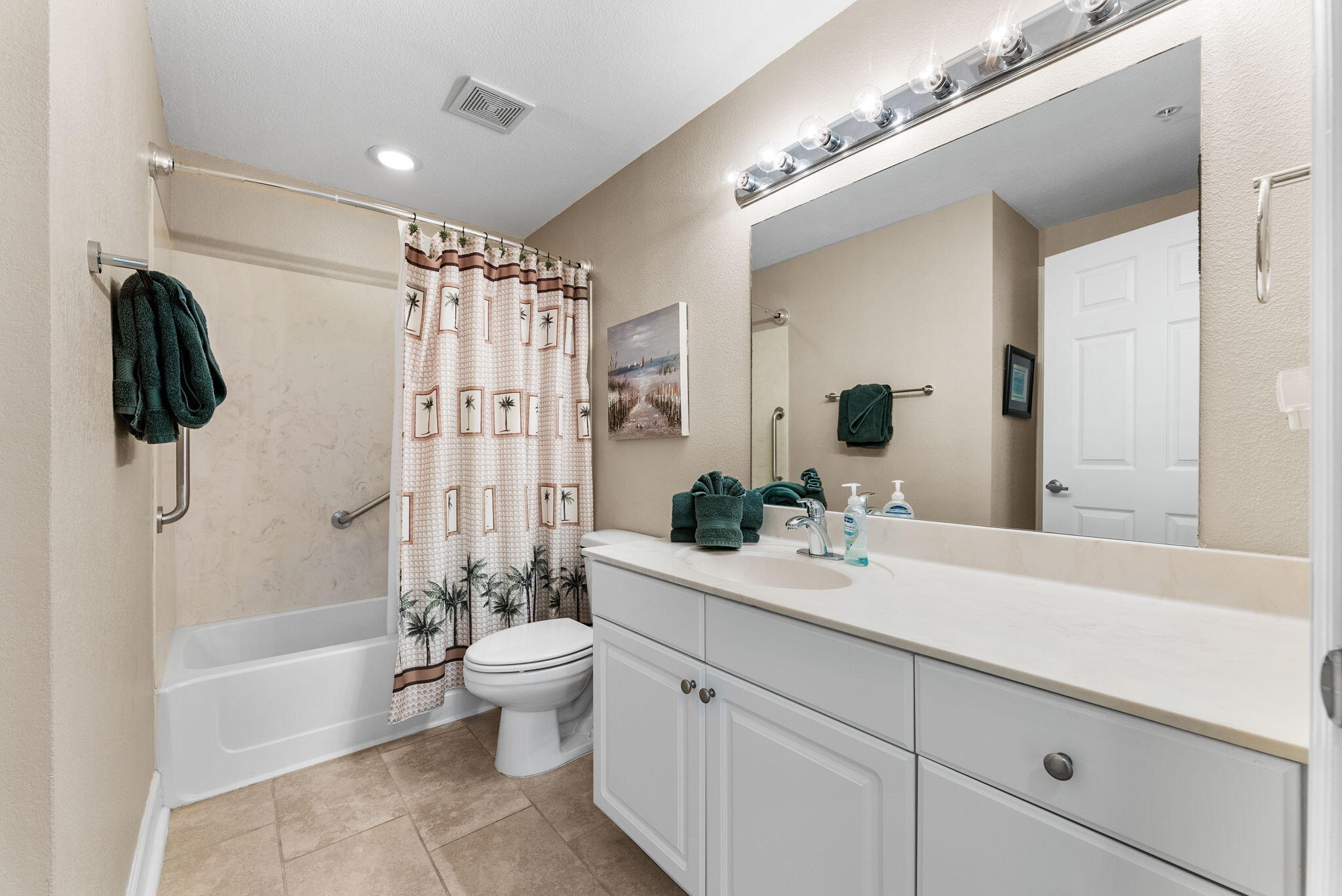 16819 Front Beach Road, Unit 405 Panama City Beach, FL 32413 - Photo 24 of 48 a bathroom with a double vanity sink toilet mirror and shower