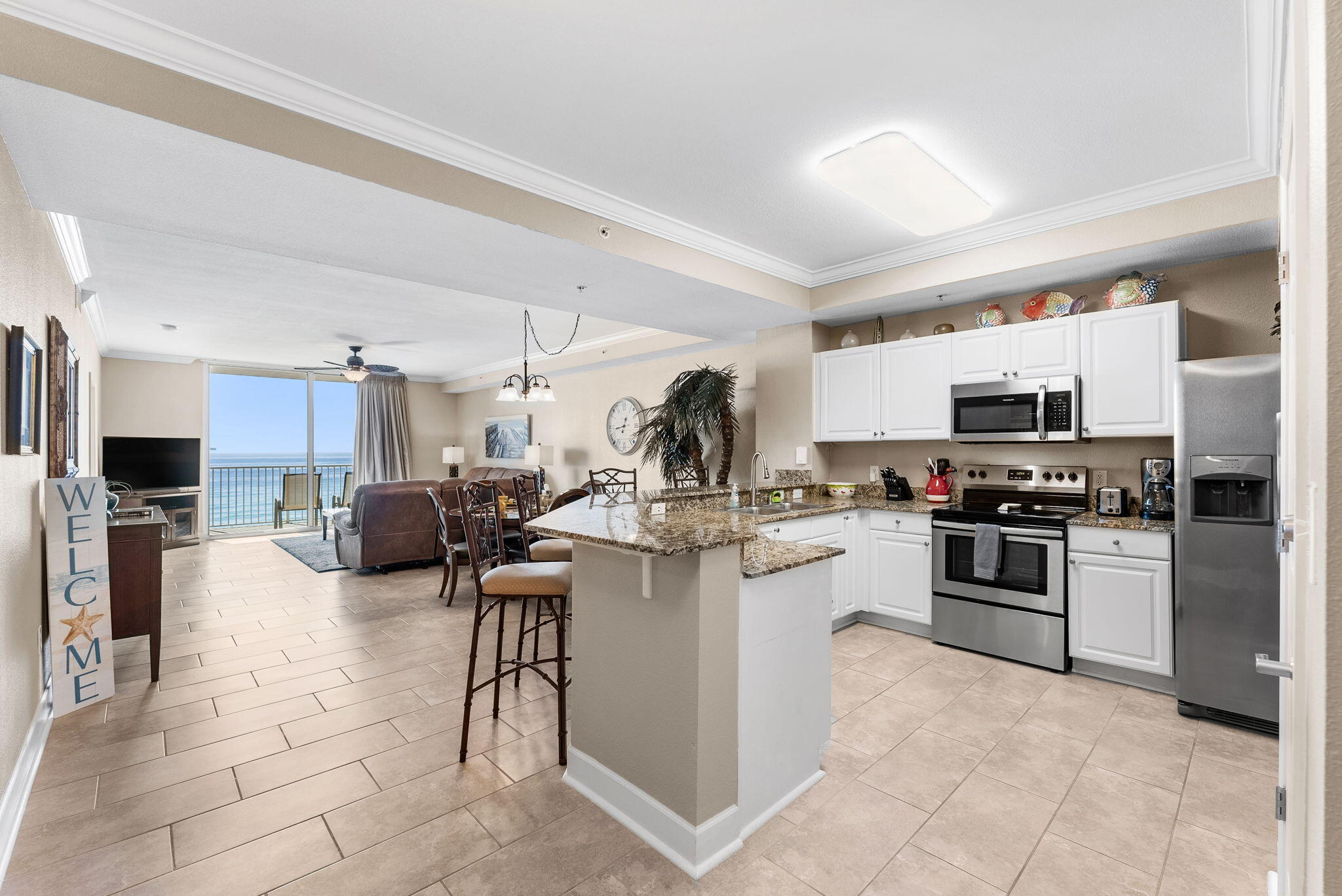 16819 Front Beach Road, Unit 405 Panama City Beach, FL 32413 - Photo 4 of 48 a kitchen with a sink cabinets and stainless steel appliances
