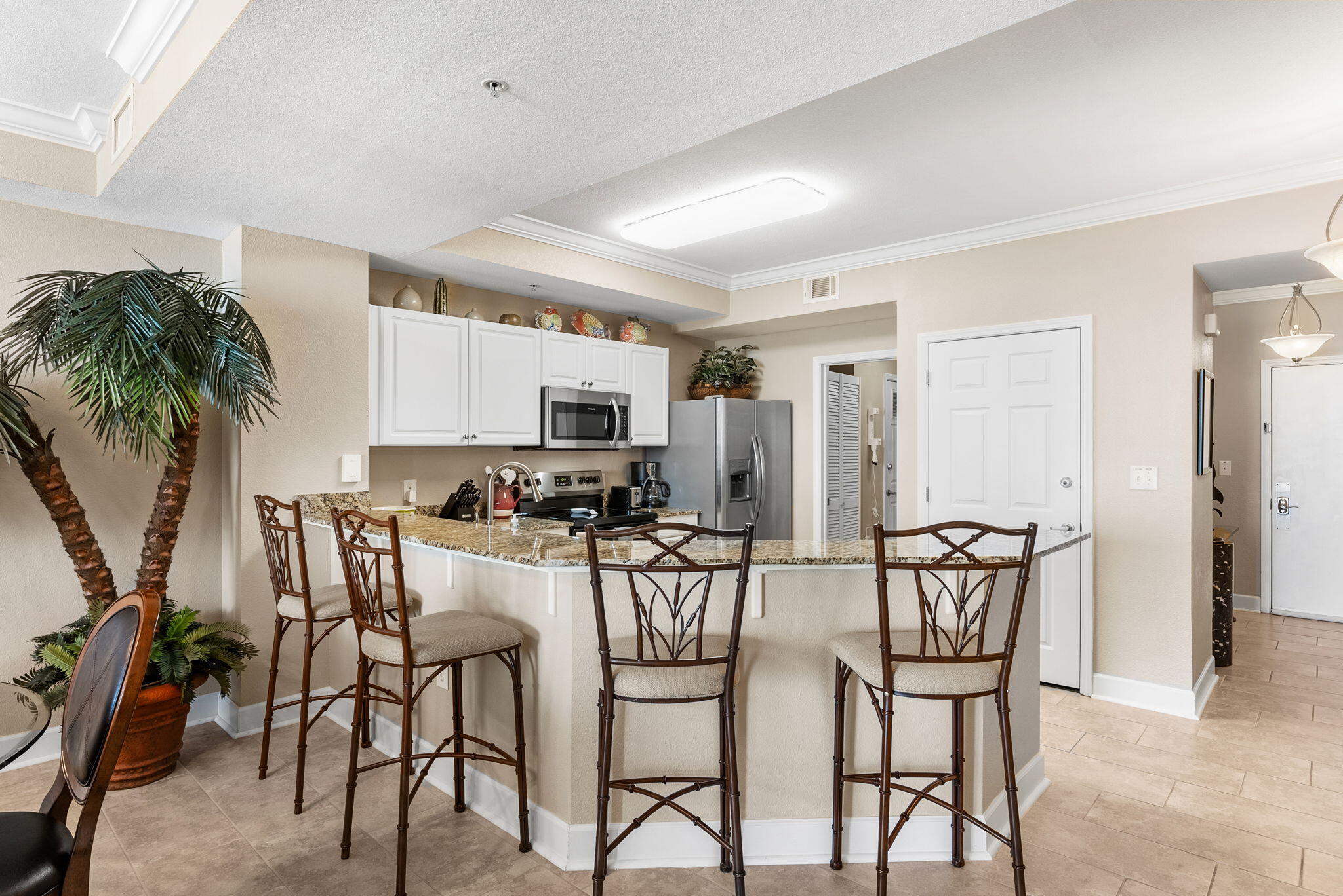 16819 Front Beach Road, Unit 405 Panama City Beach, FL 32413 - Photo 7 of 48 a view of a dining room with furniture and a kitchen
