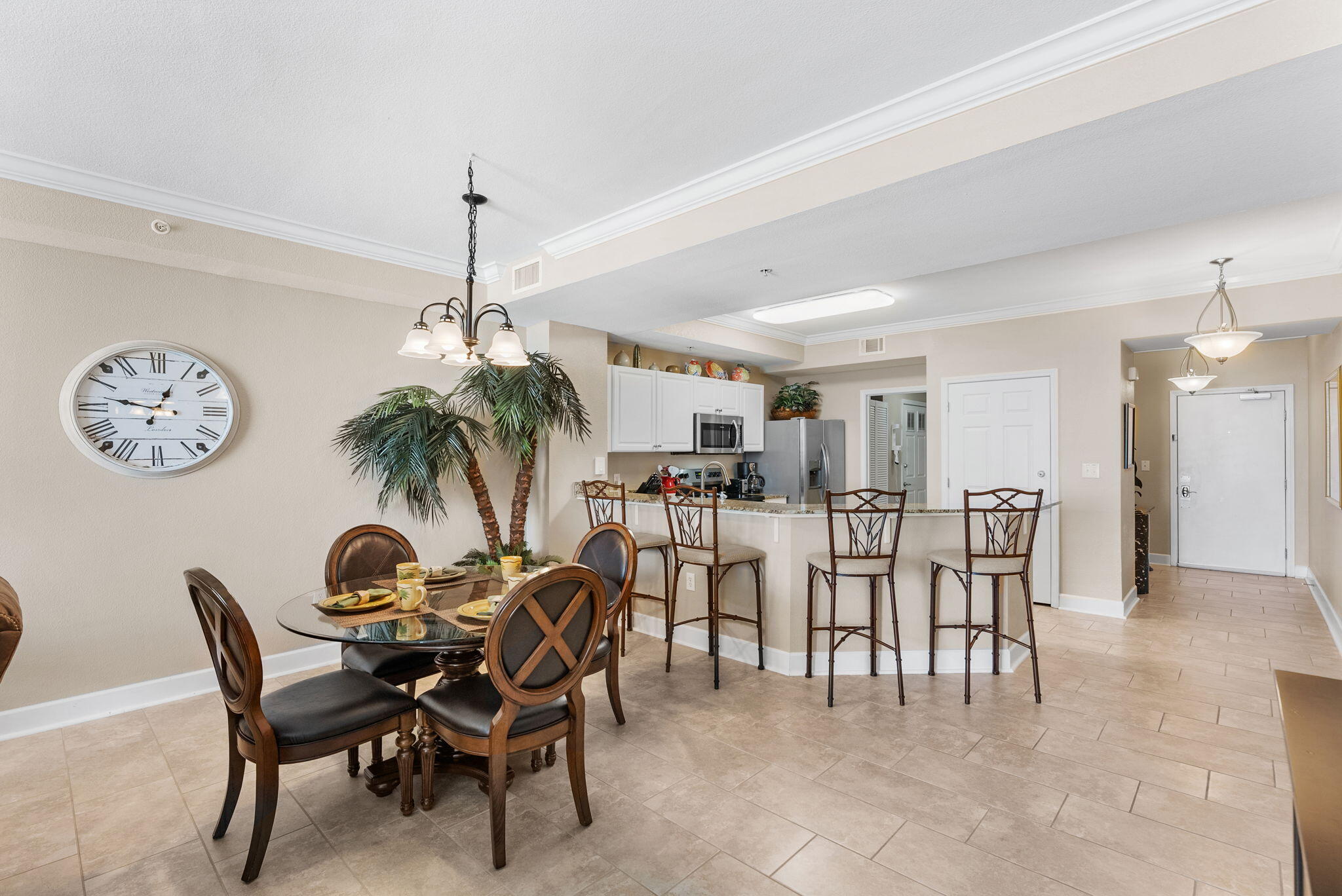 16819 Front Beach Road, Unit 405 Panama City Beach, FL 32413 - Photo 9 of 48 a dining room with furniture and a chandelier