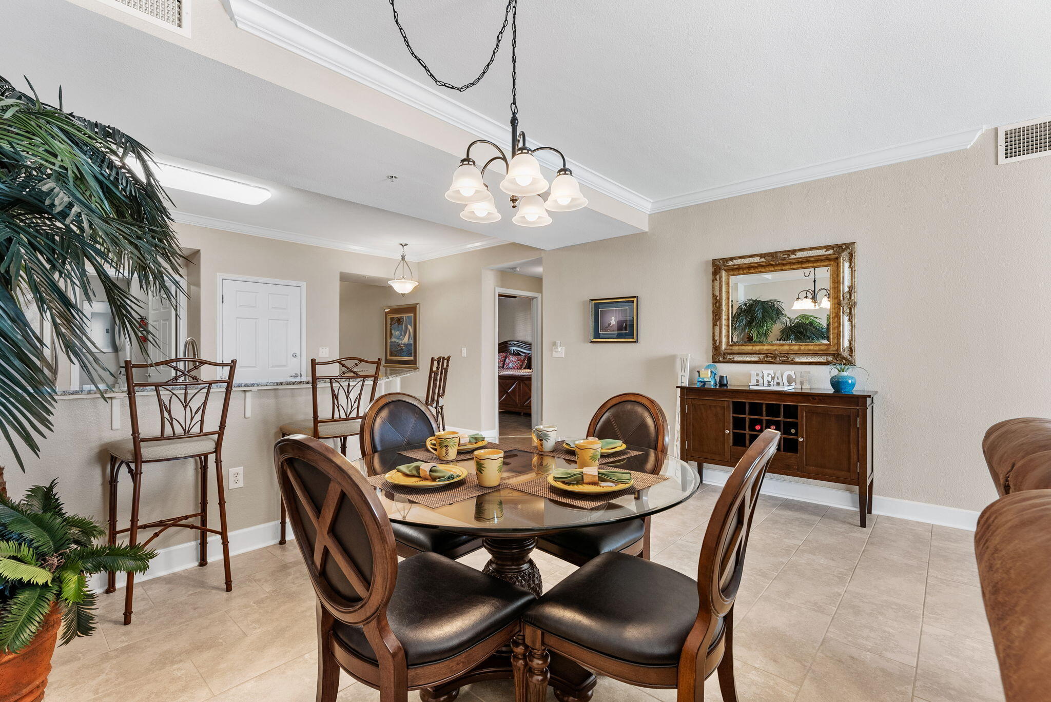 16819 Front Beach Road, Unit 405 Panama City Beach, FL 32413 - Photo 10 of 48 a view of a dining room with furniture and chandelier