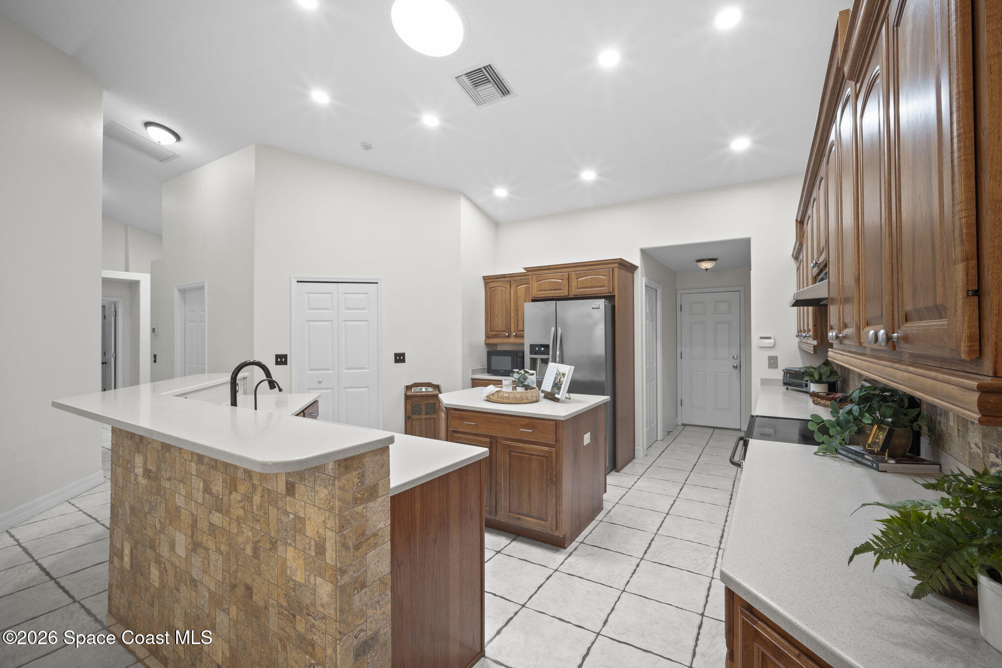 3125 Davis Road Mims, FL 32754 - Photo 22 of 47 a kitchen with stainless steel appliances granite countertop a sink a stove and a refrigerator