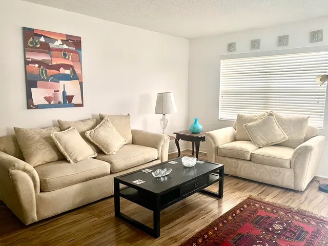 a view of a hallway with windows and entryway