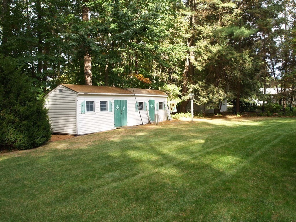 15 Clarissa Road Chelmsford, MA 01824 - Photo 17 of 22 a backyard of a house with table and chairs