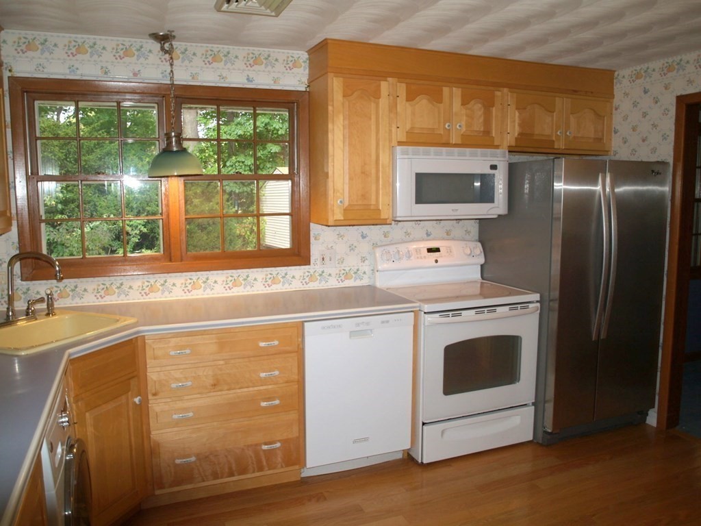 15 Clarissa Road Chelmsford, MA 01824 - Photo 3 of 22 a kitchen with a stove a sink and a refrigerator