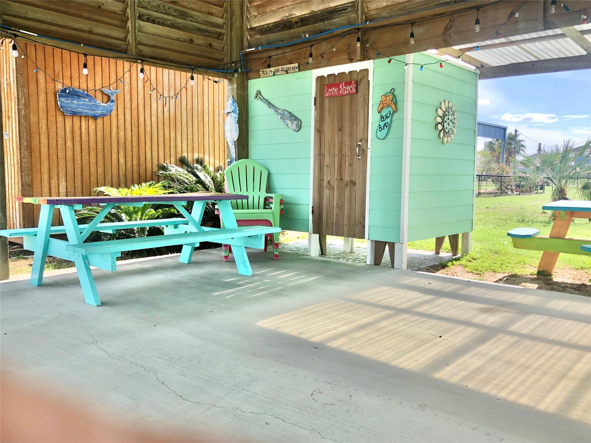 911 E Road Crystal Beach, TX 77650 - Photo 8 of 18 a view of backyard with a table and chairs and potted plants