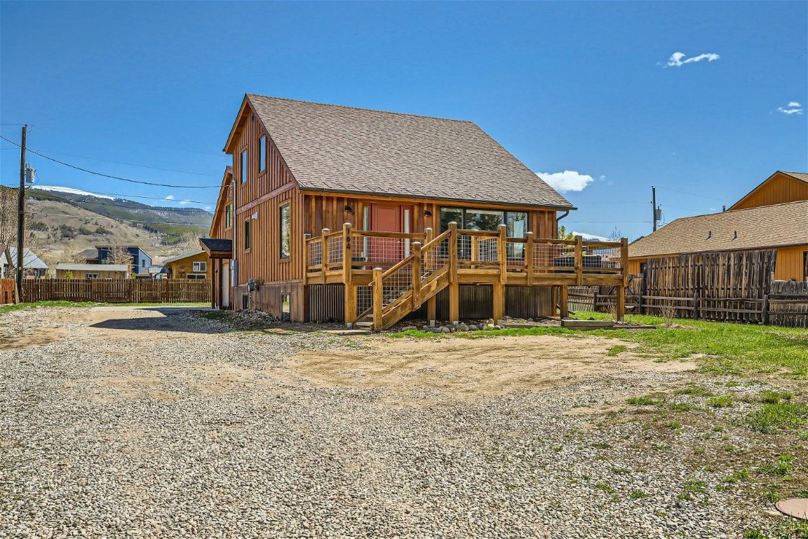 Rear view of property featuring a deck with mountain view
