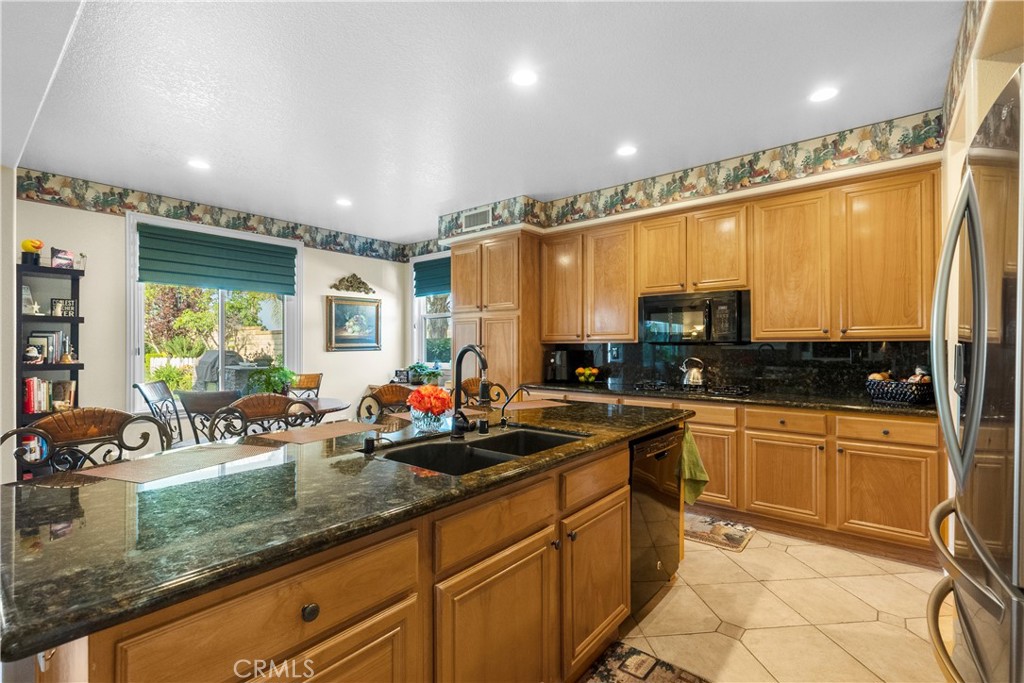 28834 Rock Canyon Drive Saugus, CA 91390 - Photo 17 of 58 a kitchen with stainless steel appliances granite countertop a sink stove and cabinets
