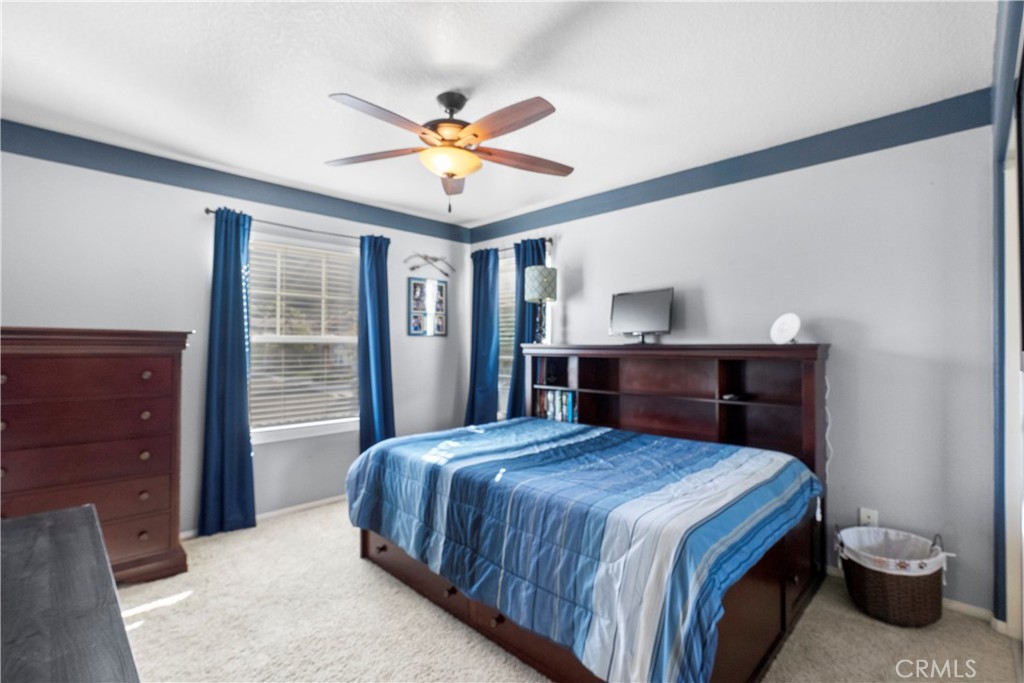 28834 Rock Canyon Drive Saugus, CA 91390 - Photo 28 of 58 a bedroom with a bed and a chandelier