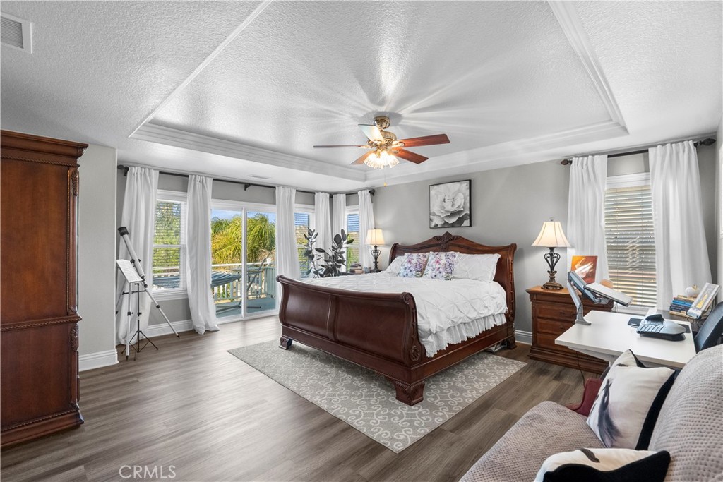 28834 Rock Canyon Drive Saugus, CA 91390 - Photo 30 of 58 a spacious bedroom with a balcony a bed and a large window with wooden floor
