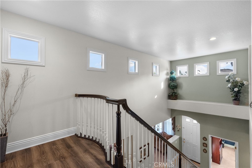 28834 Rock Canyon Drive Saugus, CA 91390 - Photo 36 of 58 a view of a hallway with wooden floor and stairs