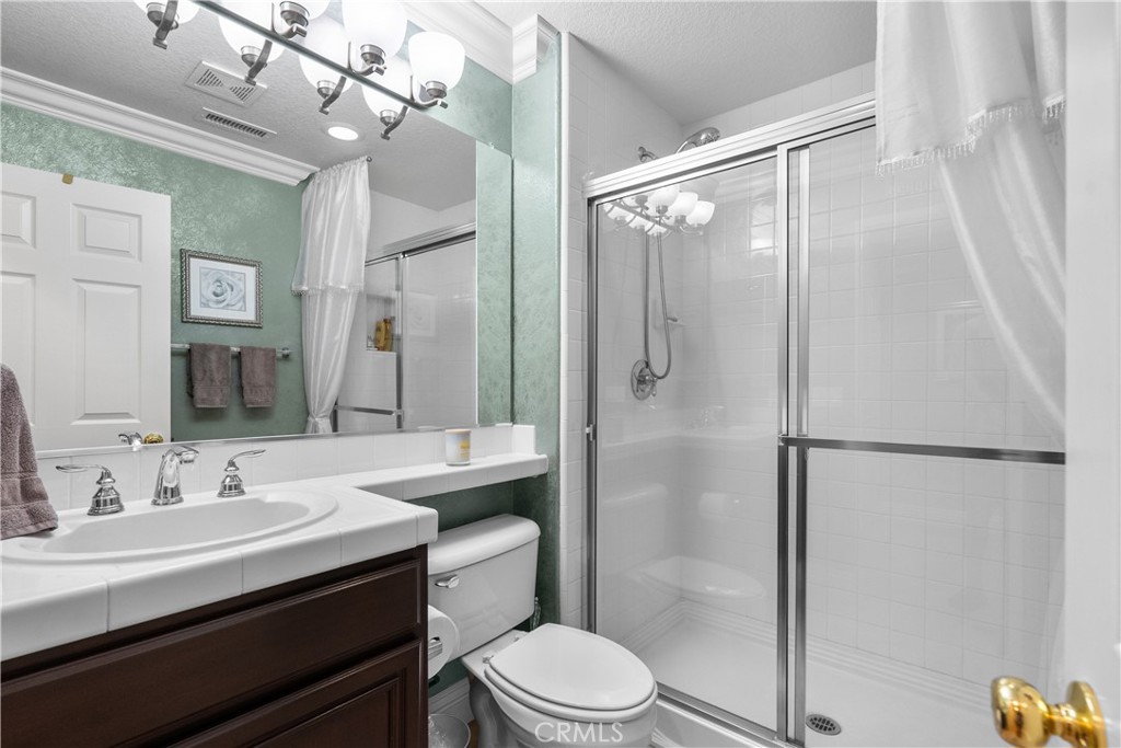 28834 Rock Canyon Drive Saugus, CA 91390 - Photo 37 of 58 a bathroom with a sink toilet a mirror and shower