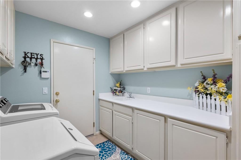 28834 Rock Canyon Drive Saugus, CA 91390 - Photo 39 of 58 a utility room with sink dryer and washer