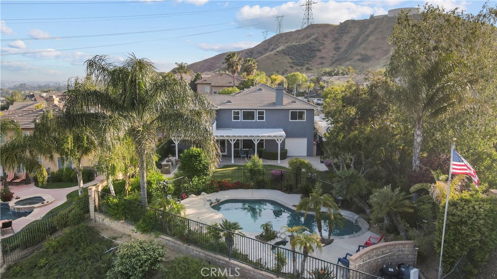 28834 Rock Canyon Drive Saugus, CA 91390 - Photo 4 of 58 a front view of a house with a yard and fountain in middle