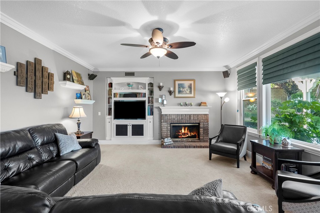 28834 Rock Canyon Drive Saugus, CA 91390 - Photo 45 of 58 a living room with furniture a flat screen tv and a fireplace