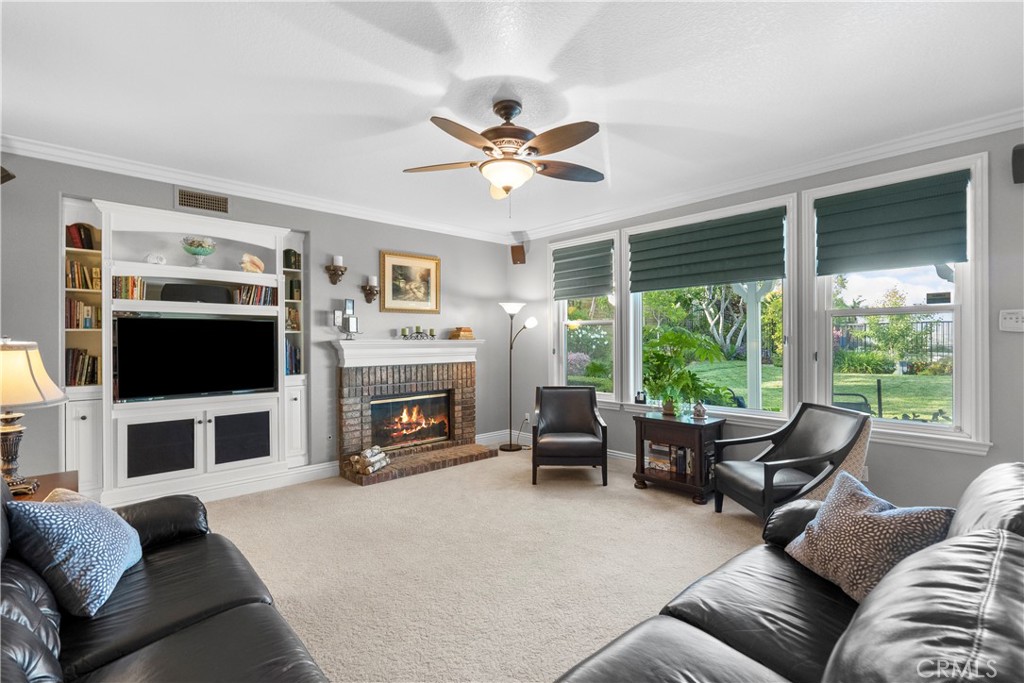 28834 Rock Canyon Drive Saugus, CA 91390 - Photo 46 of 58 a living room with furniture a fireplace and a flat screen tv