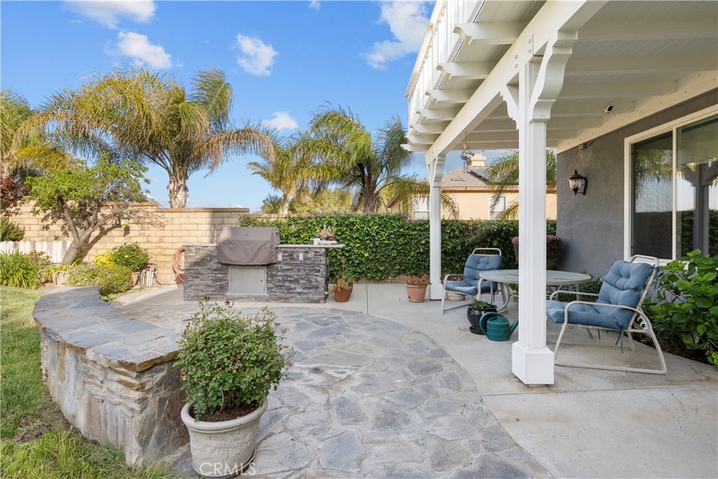 28834 Rock Canyon Drive Saugus, CA 91390 - Photo 48 of 58 a view of a patio with table and chairs potted plants