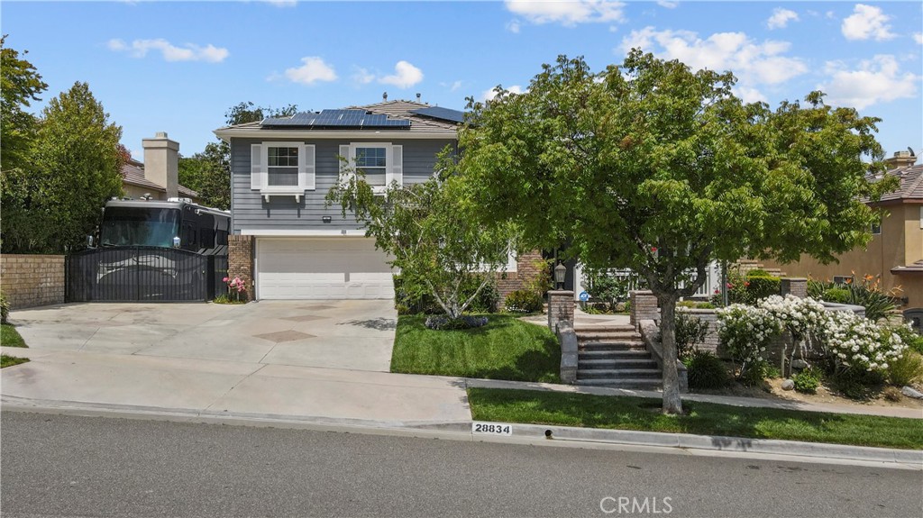 28834 Rock Canyon Drive Saugus, CA 91390 - Photo 7 of 58 a front view of a house with a yard and potted plants