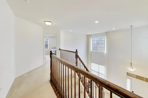 a view of a hallway with stairs