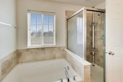 a bathroom with a bathtub and a shower