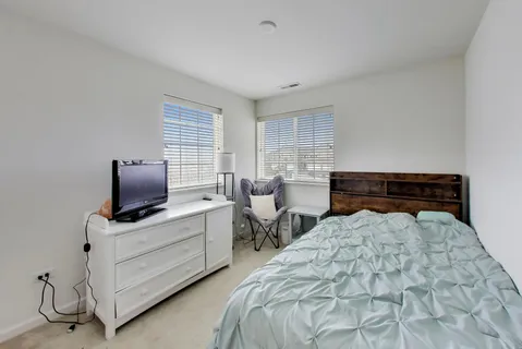 a bedroom with a bed and window