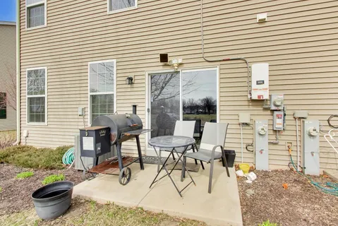 a view of a patio with table and chairs and potted plants