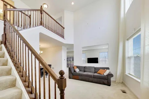 a living room with fireplace furniture and a flat screen tv