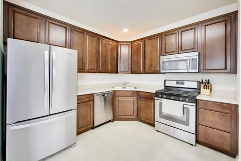 a kitchen with granite countertop cabinets and steel stainless steel appliances