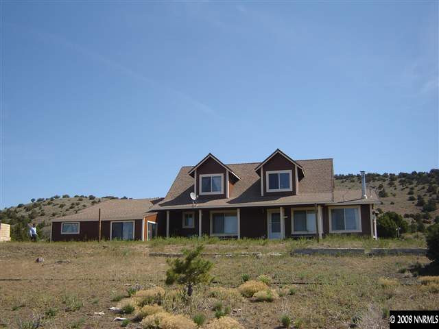 5700 Microwave Road Reno, NV 89510 - Photo 1 of 9 a front view of a house with a yard