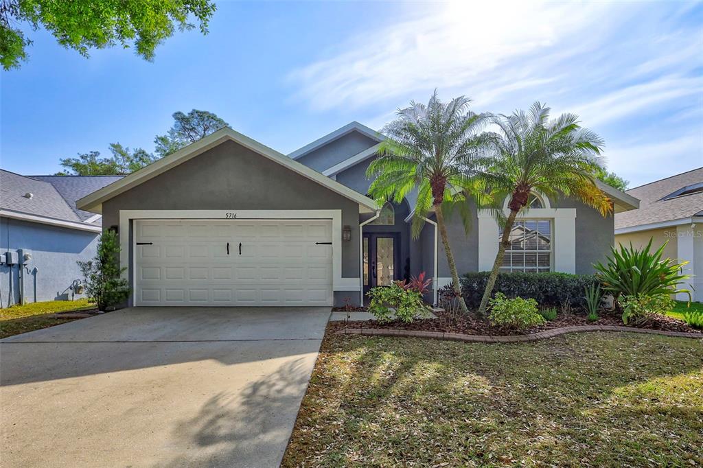 5716 Hawklake Road Lithia, FL 33547 - Photo 1 of 1 a front view of house with yard and green space