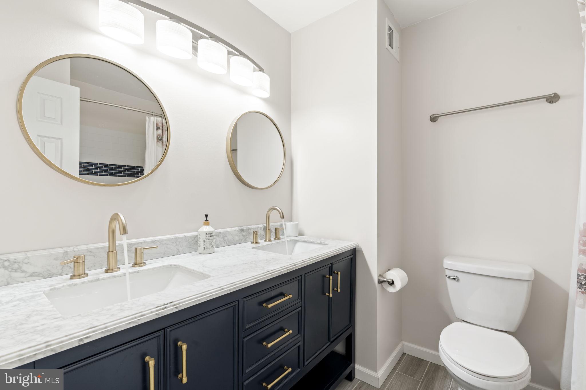 19 Chateau Circle, Unit 29 Chesterbrook, PA 19087 - Photo 29 of 40 a bathroom with a granite countertop toilet sink and mirror