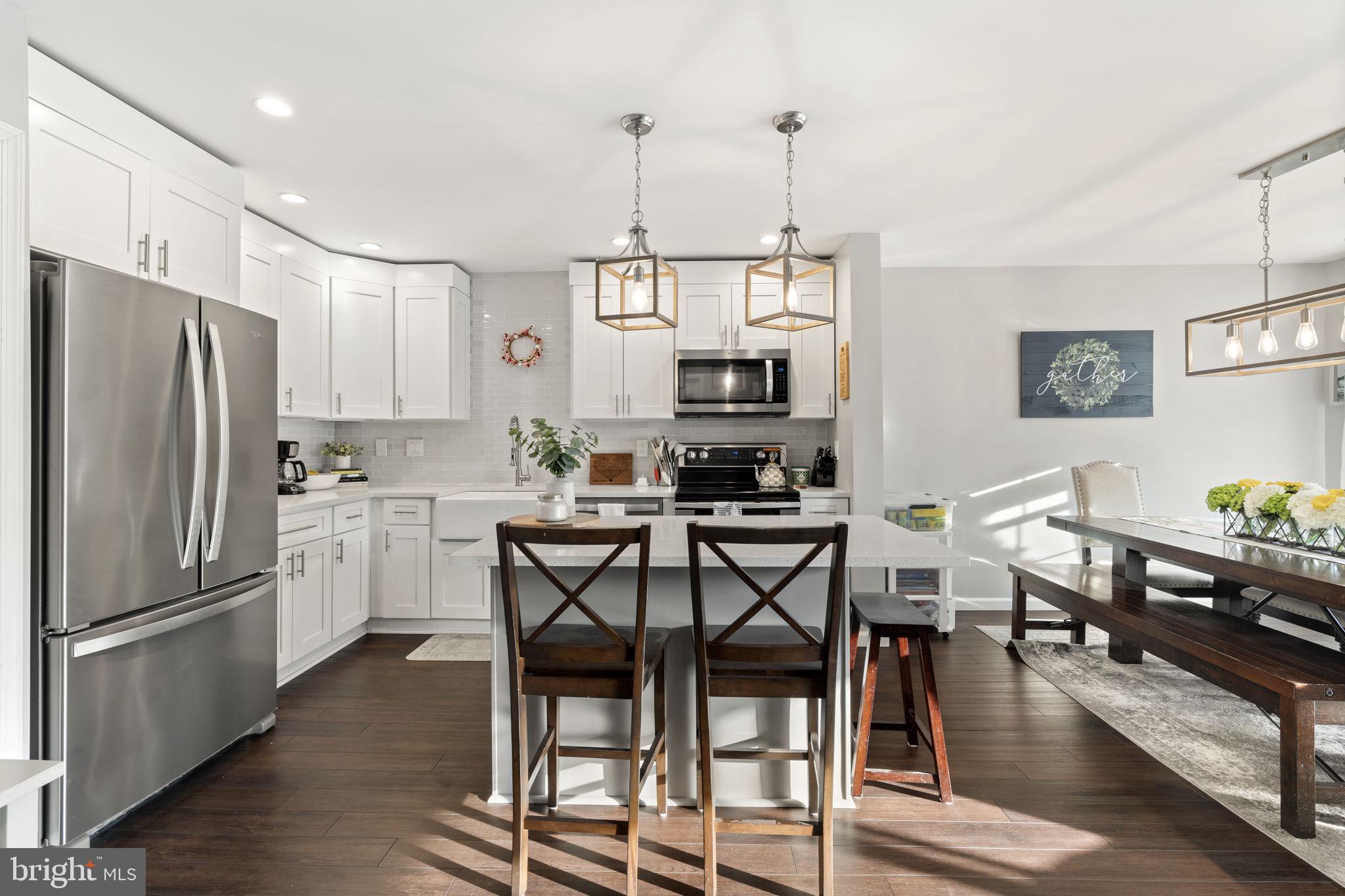 19 Chateau Circle, Unit 29 Chesterbrook, PA 19087 - Photo 7 of 40 a kitchen with stainless steel appliances a dining table chairs stove refrigerator and cabinets