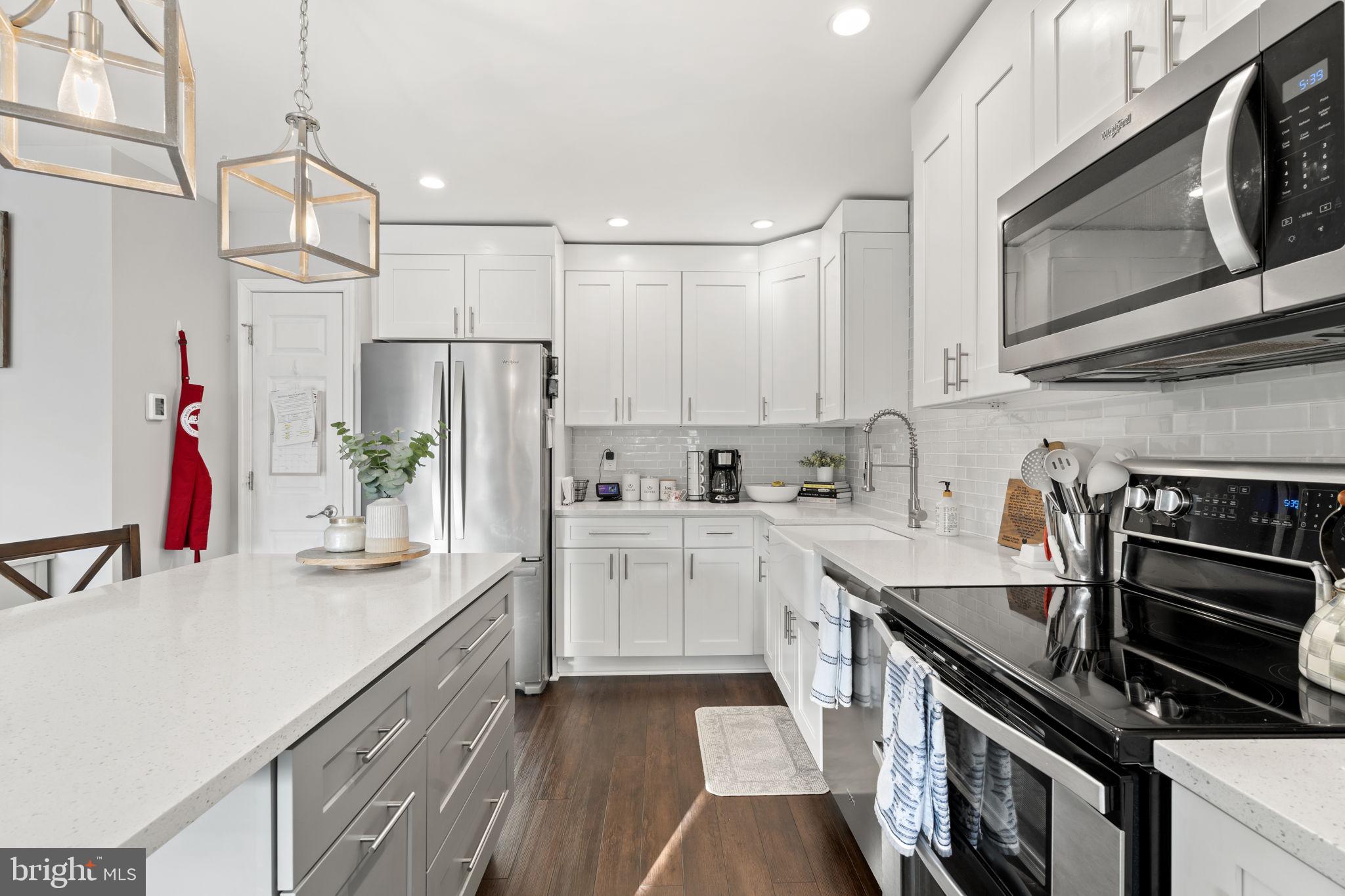 19 Chateau Circle, Unit 29 Chesterbrook, PA 19087 - Photo 9 of 40 a kitchen with kitchen island white cabinets and stainless steel appliances