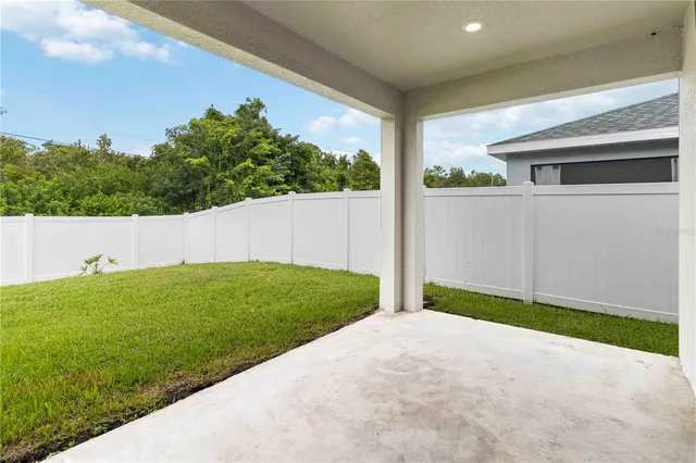 a view of a house with backyard and garden