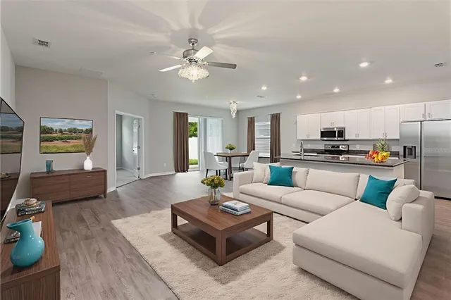 a living room with furniture and kitchen view