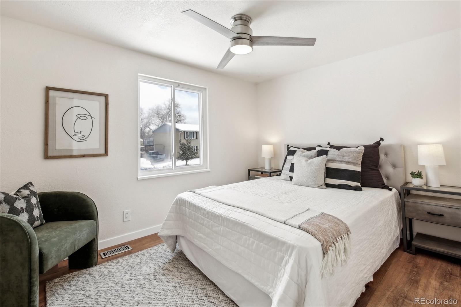 5153 Tucson Way Denver, CO 80239 - Photo 13 of 29 a bedroom with a bed couch and window