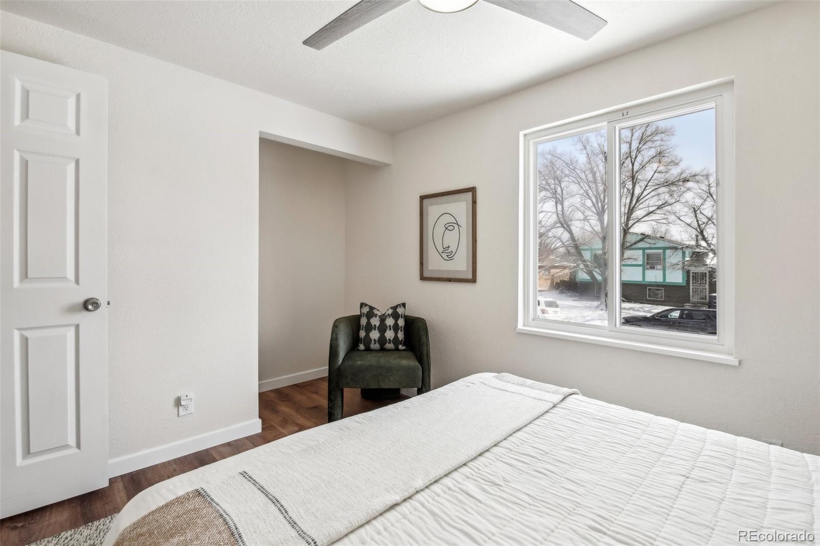 5153 Tucson Way Denver, CO 80239 - Photo 14 of 29 a bedroom with a bed and a window